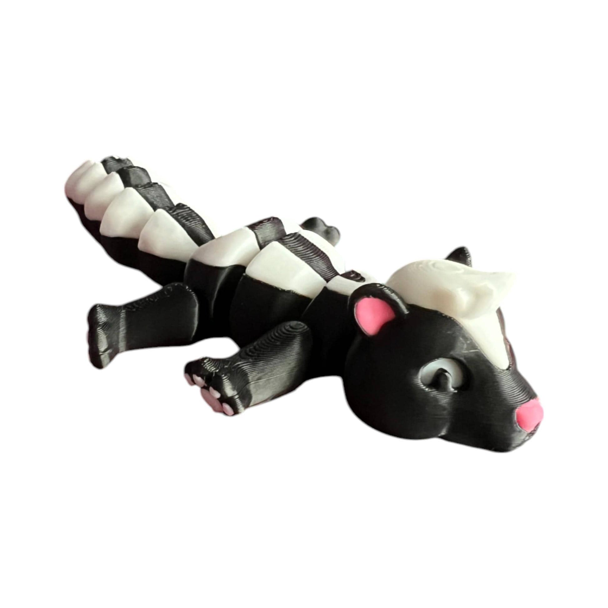Front view of a 3D-printed black and white articulated skunk fidget toy, showcasing its cute design with a flexible segmented body