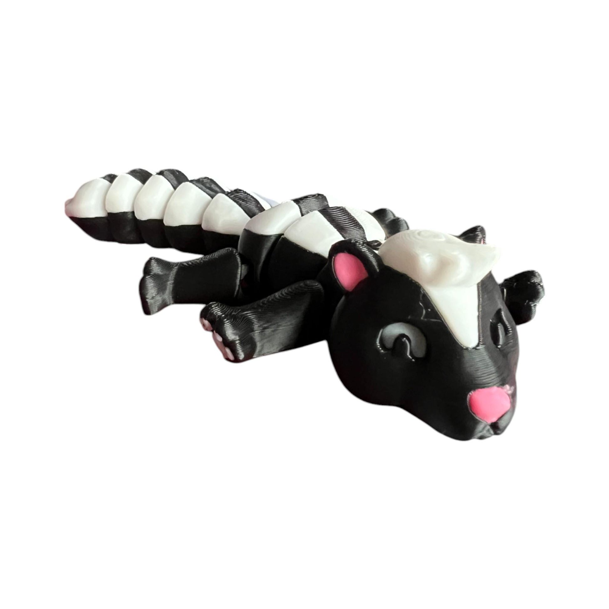 Front view of a 3D-printed black and white articulated skunk fidget toy, showcasing its cute design with a flexible segmented body