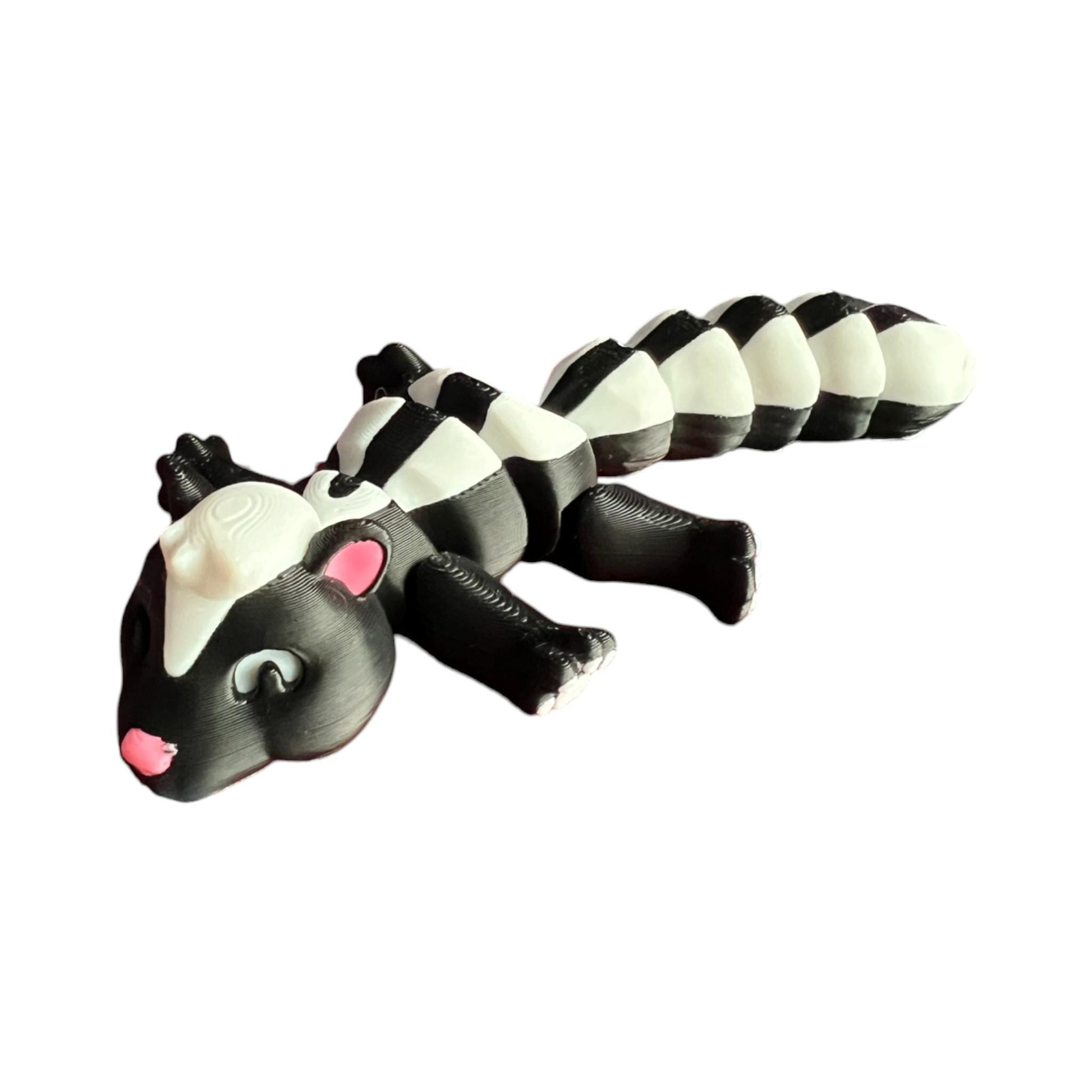 Front view of a 3D-printed black and white articulated skunk fidget toy, showcasing its cute design with a flexible segmented body