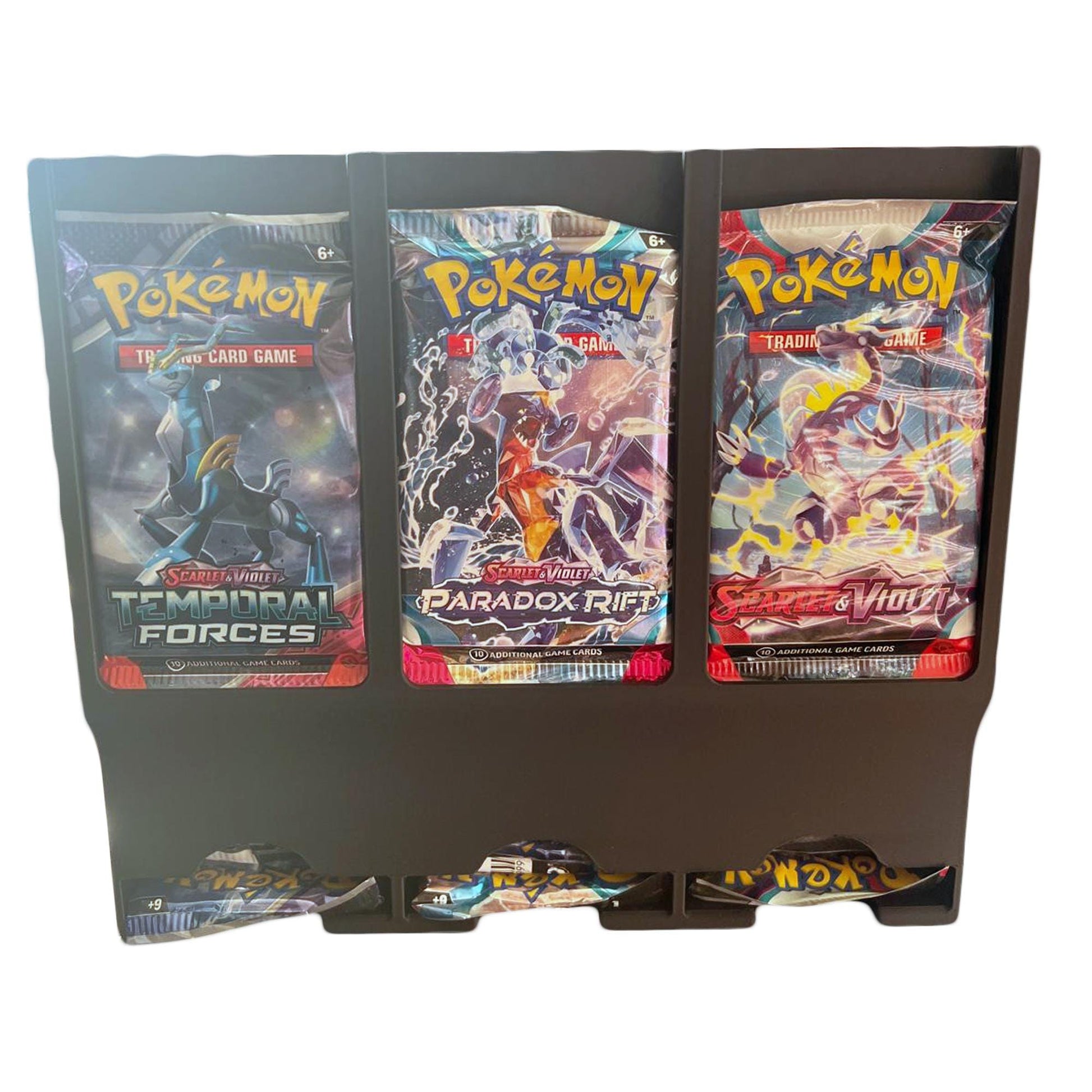 A close-up of the Pokémon card dispenser with three slots, each holding a different Pokémon card pack. The design is compact and sleek, perfect for organizing card collections.