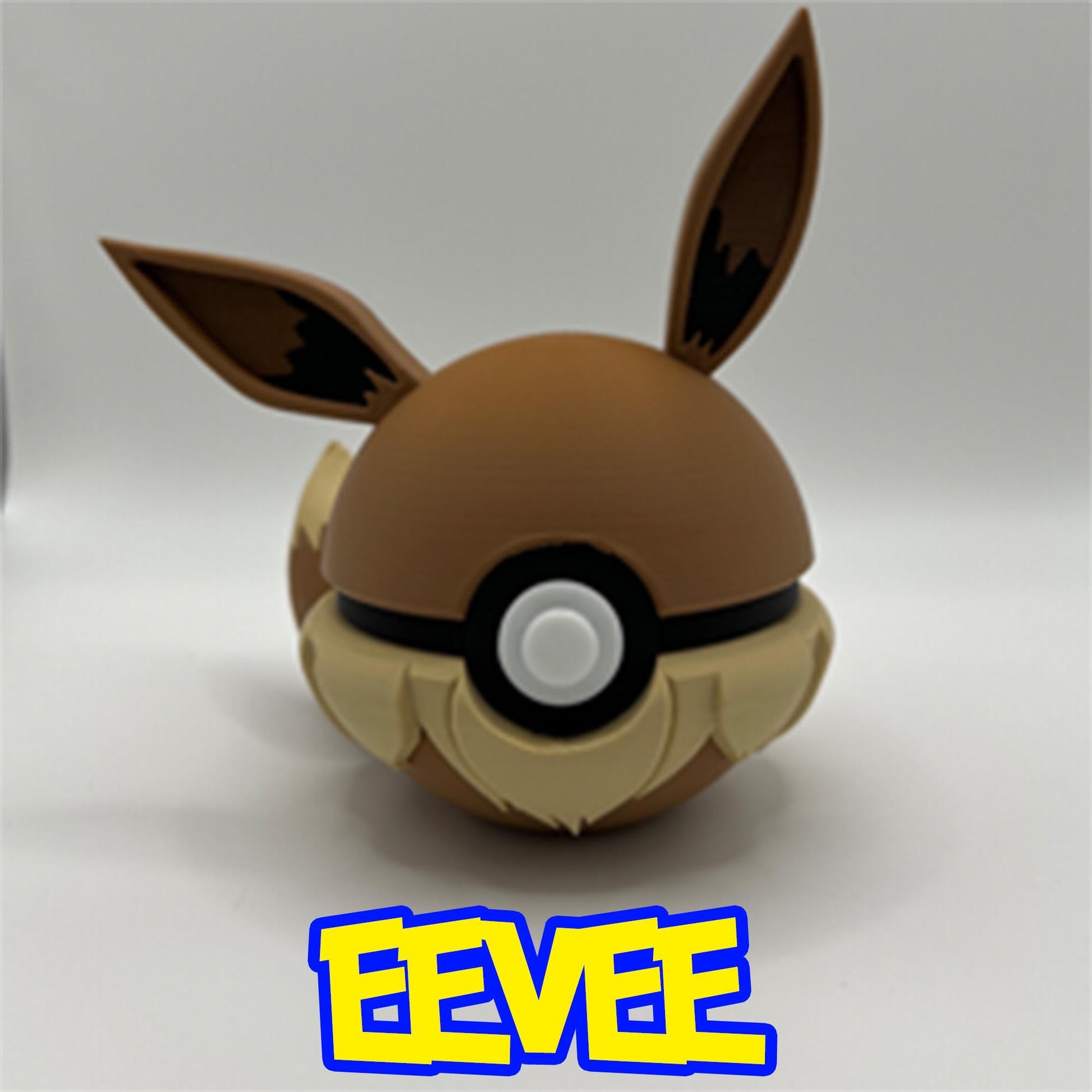 3D printed Eevee Pokéball featuring brown ears with black accents, fluffy beige collar detail, and tail, inspired by the beloved evolution Pokémon